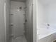 Bright bathroom with a separate shower and a luxurious soaking tub at 230 Nina Cir, Locust Grove, GA 30248