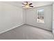 Clean bedroom features a ceiling fan and a bright, sunlit window at 230 Nina Cir, Locust Grove, GA 30248