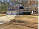 Charming two-story home featuring a well-maintained front yard, two-car garage and covered front porch at 230 Nina Cir, Locust Grove, GA 30248
