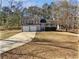 Charming home with a two-car garage, mature trees, and a well-maintained front lawn at 230 Nina Cir, Locust Grove, GA 30248