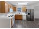 Functional kitchen with white countertops, wood cabinets, and stainless steel refrigerator at 230 Nina Cir, Locust Grove, GA 30248