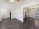 Open-concept space with new dark floors, white walls, and a view to staircase at 230 Nina Cir, Locust Grove, GA 30248