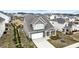 Aerial view of a two-story home featuring a two-car garage, manicured yard, and patio area at 2466 Bear Mountain St, Lithonia, GA 30058