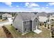 Aerial view of the back of a gray home with a small patio and landscaping at 2466 Bear Mountain St, Lithonia, GA 30058