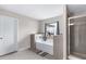 Bright bathroom features a garden tub, glass shower, and a window with neighborhood views at 2466 Bear Mountain St, Lithonia, GA 30058