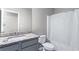Neutral bathroom featuring a granite countertop vanity, toilet and shower/tub with a curtain at 2466 Bear Mountain St, Lithonia, GA 30058