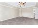 Bright Primary bedroom with a ceiling fan and door to the hallway at 2466 Bear Mountain St, Lithonia, GA 30058