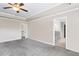Spacious bedroom with neutral walls, gray carpet, ceiling fan and ensuite bathroom access at 2466 Bear Mountain St, Lithonia, GA 30058