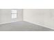 Bedroom with window, neutral walls, and gray carpet at 2466 Bear Mountain St, Lithonia, GA 30058
