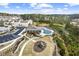 Aerial view of a modern community pool with a playground, clubhouse, and parking lot at 2466 Bear Mountain St, Lithonia, GA 30058