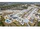 Wide aerial view of a planned community featuring a pool, playground, and numerous homes at 2466 Bear Mountain St, Lithonia, GA 30058