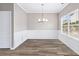 Well-lit dining room featuring modern trim, a chandelier, and a large window at 2466 Bear Mountain St, Lithonia, GA 30058