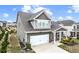 Charming two-story home with a two-car garage, a covered porch, and a landscaped yard at 2466 Bear Mountain St, Lithonia, GA 30058