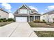 Inviting two-story home with a clean driveway, manicured lawn, and a welcoming front porch area at 2466 Bear Mountain St, Lithonia, GA 30058
