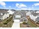 Charming two-story home featuring a well-maintained front yard with healthy green landscaping and a two-car garage at 2466 Bear Mountain St, Lithonia, GA 30058