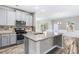 Bright kitchen featuring stainless steel appliances, granite countertops, and stylish gray cabinets at 2466 Bear Mountain St, Lithonia, GA 30058