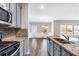 Contemporary kitchen featuring stainless steel appliances and a breakfast bar overlooking the dining area at 2466 Bear Mountain St, Lithonia, GA 30058
