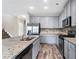 Spacious kitchen with granite counters, stainless steel appliances, and stylish gray cabinetry at 2466 Bear Mountain St, Lithonia, GA 30058