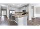 Modern kitchen featuring stainless steel appliances, granite countertops, ample cabinet space, and hardwood flooring at 2466 Bear Mountain St, Lithonia, GA 30058