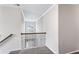 Upstairs landing with wood and iron railing, carpeted floor and view to a window at 2466 Bear Mountain St, Lithonia, GA 30058
