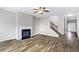 Spacious living room with hardwood floors, fireplace, staircase and neutral colors creating a warm, inviting atmosphere at 2466 Bear Mountain St, Lithonia, GA 30058