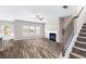 Open-concept living room featuring a fireplace, large windows, and hardwood flooring at 2466 Bear Mountain St, Lithonia, GA 30058