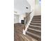 Carpeted staircase with decorative iron railing at 2466 Bear Mountain St, Lithonia, GA 30058