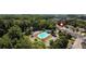 Aerial shot of a pool, parking and a variety of townhomes amidst lush greenery at 258 Ridge Mill Dr, Acworth, GA 30102