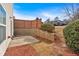 Landscaped backyard with stone retaining wall, wooden fence, and lush greenery offer a private outdoor retreat at 258 Ridge Mill Dr, Acworth, GA 30102
