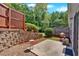 Private backyard showcasing a wood fence, patio and mature trees with lush landscaping at 258 Ridge Mill Dr, Acworth, GA 30102