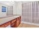 The bathroom is equipped with cabinets, a large mirror, and a shower with a patterned curtain at 258 Ridge Mill Dr, Acworth, GA 30102