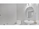 Clean bathroom with pedestal sink, toilet, and oval mirror at 258 Ridge Mill Dr, Acworth, GA 30102