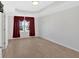 A well-lit bedroom featuring hardwood floors, neutral wall colors, and a window with red curtains at 258 Ridge Mill Dr, Acworth, GA 30102