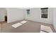 An empty bedroom featuring carpet flooring, neutral wall colors, and two windows providing natural light at 258 Ridge Mill Dr, Acworth, GA 30102