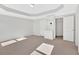 Bright bedroom featuring neutral carpet, tray ceiling, and closet for ample storage at 258 Ridge Mill Dr, Acworth, GA 30102