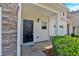 Inviting entryway with a black front door, stone accents, and a neatly landscaped garden at 258 Ridge Mill Dr, Acworth, GA 30102