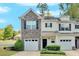 Charming townhouse with stone accents, a one-car garage, and a well-manicured front yard at 258 Ridge Mill Dr, Acworth, GA 30102