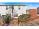 Rear exterior view of a well-maintained townhome with tidy landscaping and privacy fence at 258 Ridge Mill Dr, Acworth, GA 30102