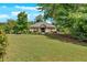 Tan single-story building nestled among trees and a green lawn under a bright, blue sky at 258 Ridge Mill Dr, Acworth, GA 30102