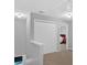 Bright hallway featuring neutral carpet, white walls, and a view into the nearby bedroom at 258 Ridge Mill Dr, Acworth, GA 30102