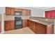 Kitchen area featuring wooden cabinets, modern appliances, and granite counters for food preparation at 258 Ridge Mill Dr, Acworth, GA 30102
