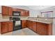 Updated kitchen featuring wooden cabinets, tile backsplash, and sleek black appliances at 258 Ridge Mill Dr, Acworth, GA 30102