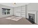 Bright living room with built-in shelving, a fireplace, and natural light at 258 Ridge Mill Dr, Acworth, GA 30102