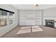 Cozy living room featuring custom built-ins, a fireplace, and large windows at 258 Ridge Mill Dr, Acworth, GA 30102