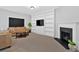 Comfortable living room with fireplace, carpet and large built-in shelving and media center at 258 Ridge Mill Dr, Acworth, GA 30102