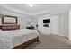 This main bedroom features neutral paint, carpet, a TV, and a coordinating dresser at 258 Ridge Mill Dr, Acworth, GA 30102