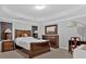 Spacious bedroom showcasing tray ceilings, neutral walls, carpet and coordinating wood furniture at 258 Ridge Mill Dr, Acworth, GA 30102