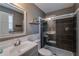 Beautiful bathroom featuring dark gray tiled walls, glass shower doors, and a white vanity at 3570 Mill Creek Drive Sw Dr, Smyrna, GA 30082