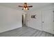 This light-filled bedroom features light gray flooring, ceiling fan, and access to another room at 3570 Mill Creek Drive Sw Dr, Smyrna, GA 30082