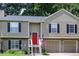 Charming home with a red door, black shutters, and an American flag at 3570 Mill Creek Drive Sw Dr, Smyrna, GA 30082